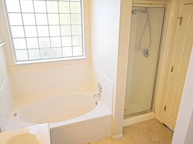 bathroom with tile patterned floors and plus walk in shower