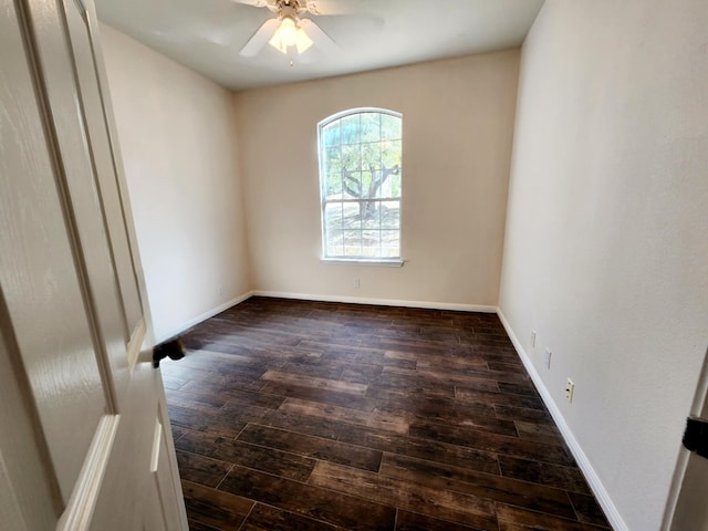 empty room with dark wood-type flooring and ceiling fan