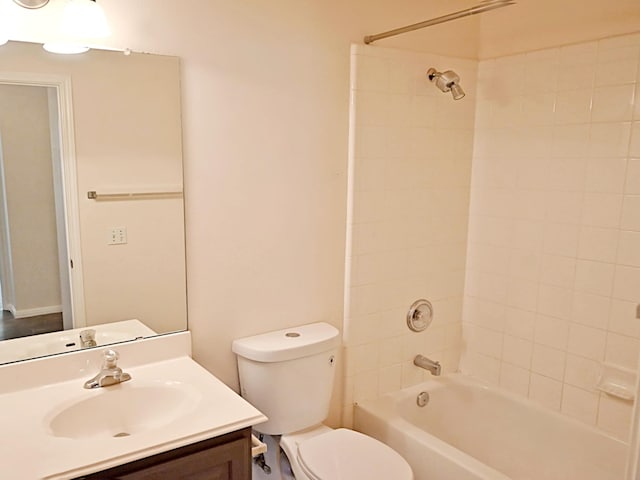 full bathroom with tiled shower / bath combo, vanity, and toilet