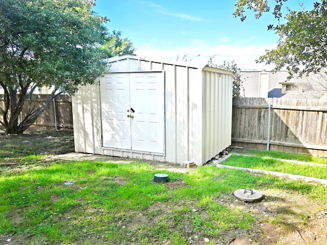 view of outbuilding featuring a yard