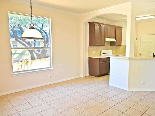 kitchen featuring decorative backsplash, pendant lighting, light tile patterned floors, and crown molding