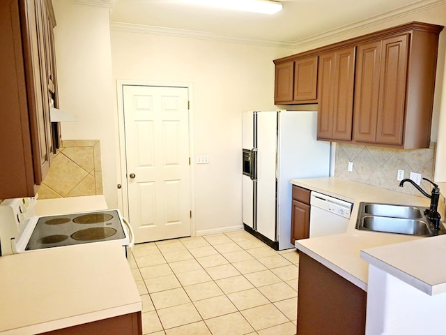 kitchen with white appliances, decorative backsplash, sink, ornamental molding, and light tile patterned floors