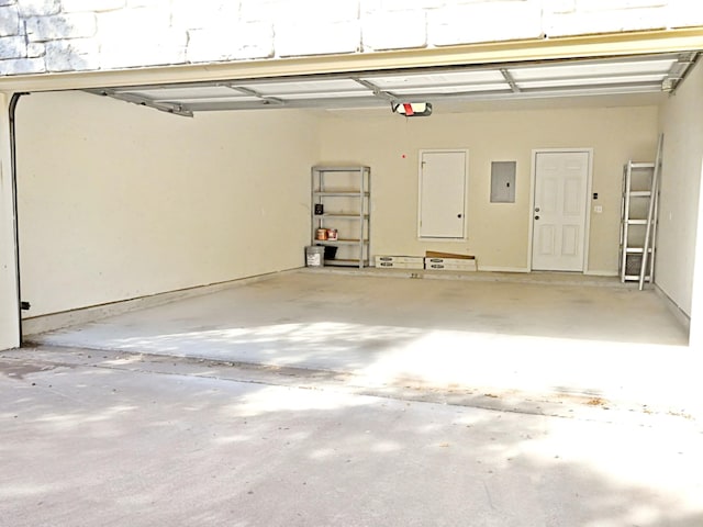 garage featuring a garage door opener and electric panel