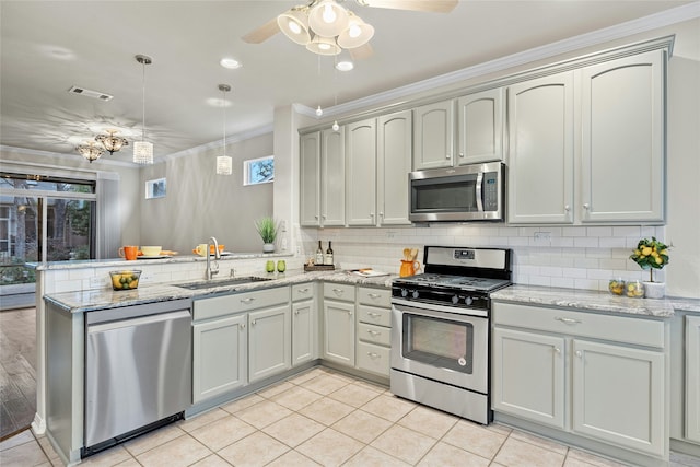 kitchen featuring kitchen peninsula, sink, crown molding, appliances with stainless steel finishes, and light stone counters