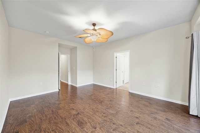 empty room with ceiling fan and dark hardwood / wood-style flooring