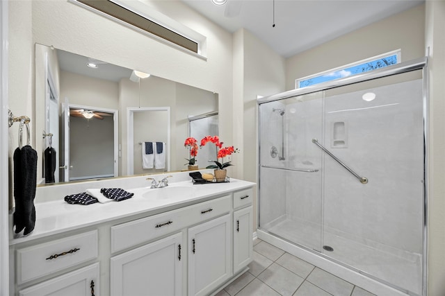 bathroom featuring ceiling fan, tile patterned floors, vanity, and a shower with door