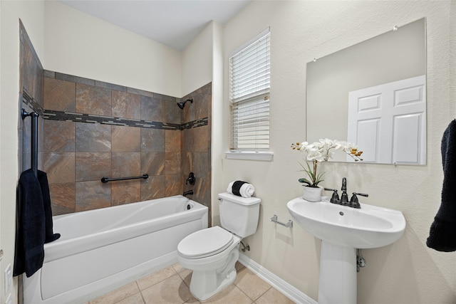 bathroom featuring toilet, tiled shower / bath, and tile patterned flooring