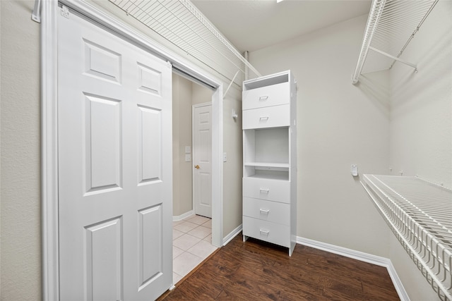 spacious closet featuring dark hardwood / wood-style flooring