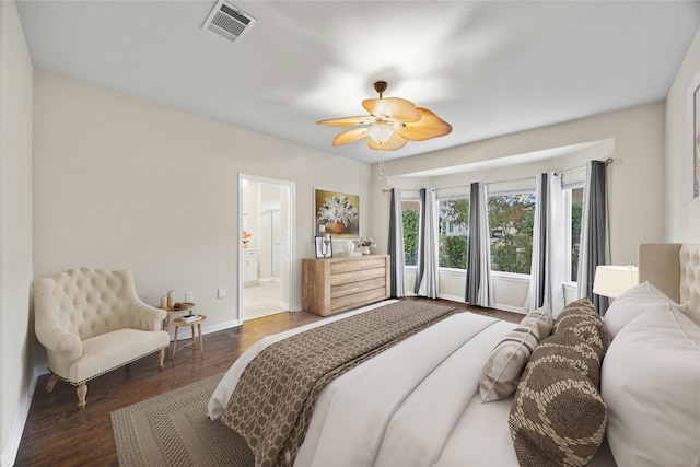 bedroom with ceiling fan, dark hardwood / wood-style flooring, and ensuite bath