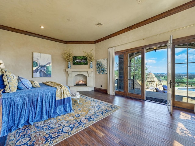 bedroom with dark wood-type flooring, access to exterior, and ornamental molding