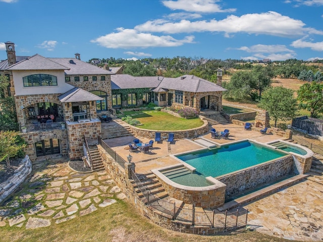 view of swimming pool with an outdoor bar, a patio area, and an in ground hot tub