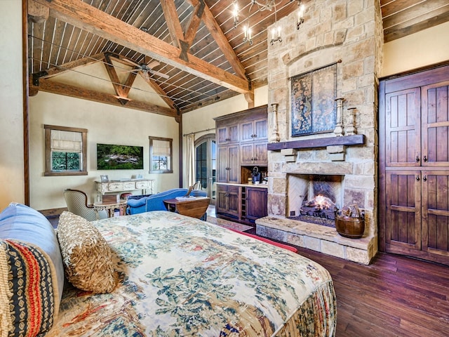 bedroom with wooden ceiling, dark hardwood / wood-style floors, a fireplace, high vaulted ceiling, and beamed ceiling