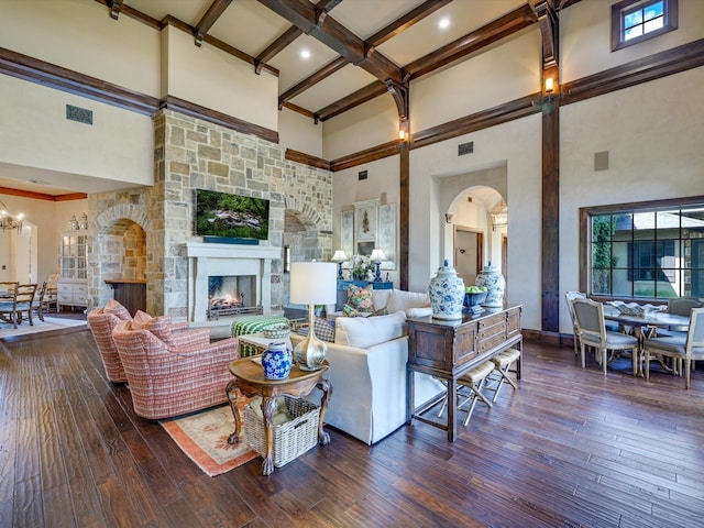 living room with dark hardwood / wood-style floors, a fireplace, and a high ceiling