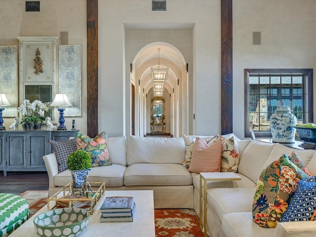 living room with hardwood / wood-style flooring and a notable chandelier