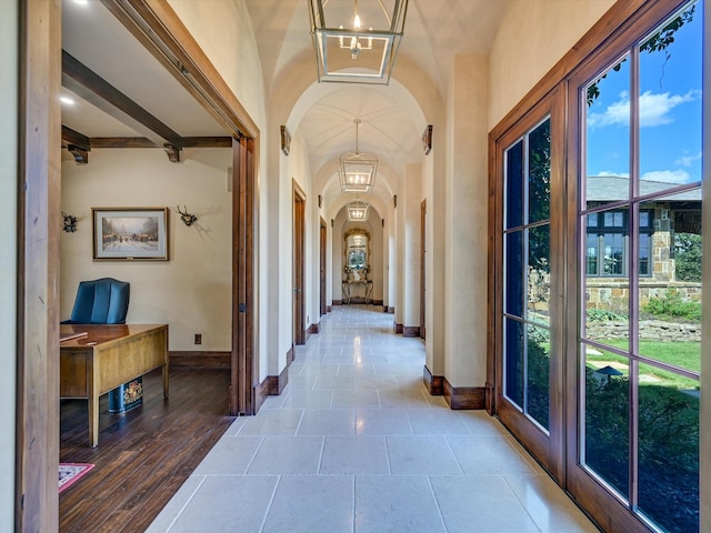 hallway with an inviting chandelier and french doors