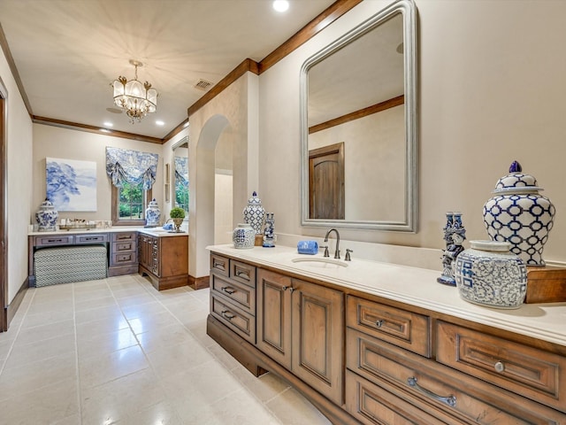 bathroom featuring tile patterned floors, vanity, crown molding, and an inviting chandelier