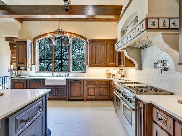 kitchen featuring double oven range, decorative backsplash, beam ceiling, and sink