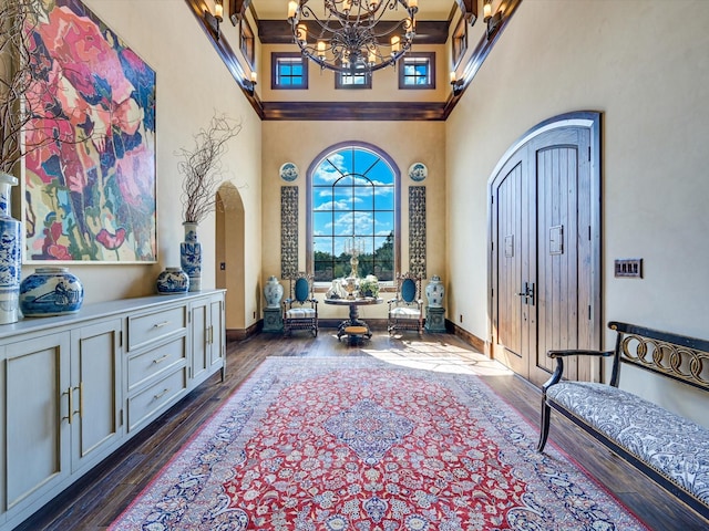 sitting room with dark wood-type flooring and a towering ceiling