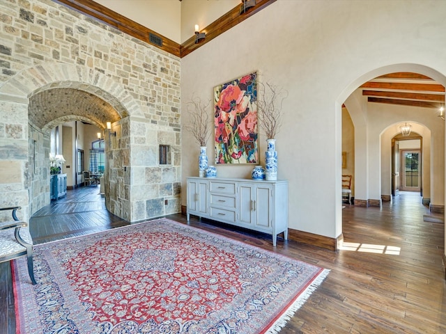 corridor with hardwood / wood-style floors and beamed ceiling