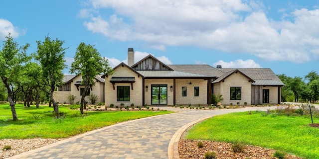 200 E Eldorado Ridge Dr, Fredericksburg, TX 78624 - view of front facade featuring a chimney, a standing seam roof, stone siding, and a front yard