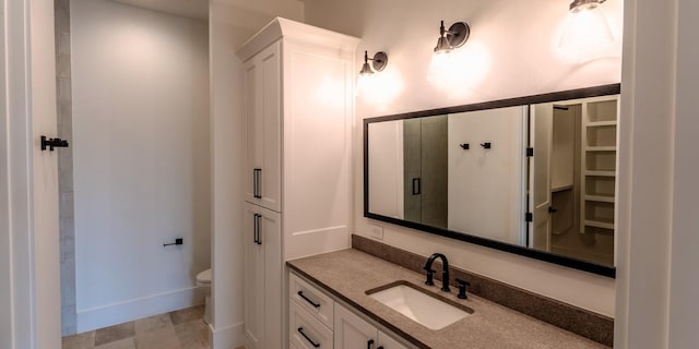 200 E Eldorado Ridge Dr, Fredericksburg, TX 78624 - full bathroom with vanity, toilet, a shower, a closet, and baseboards