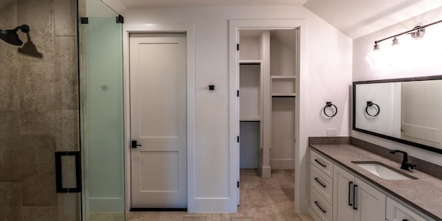 200 E Eldorado Ridge Dr, Fredericksburg, TX 78624 - full bathroom with a shower stall, vanity, a walk in closet, and vaulted ceiling