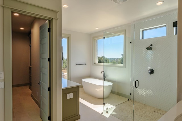 bathroom featuring separate shower and tub and vanity