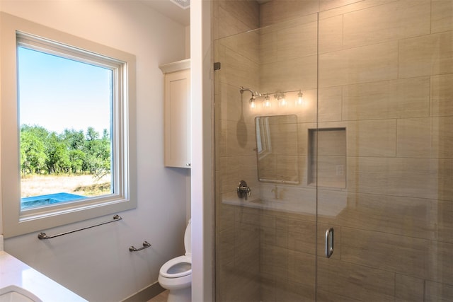 bathroom featuring toilet and an enclosed shower