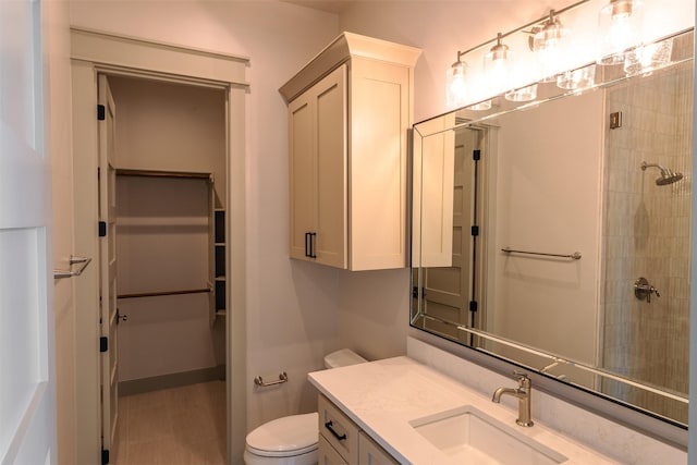 bathroom with vanity, toilet, and walk in shower