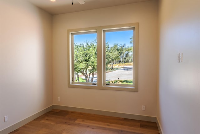 spare room with ceiling fan and hardwood / wood-style flooring