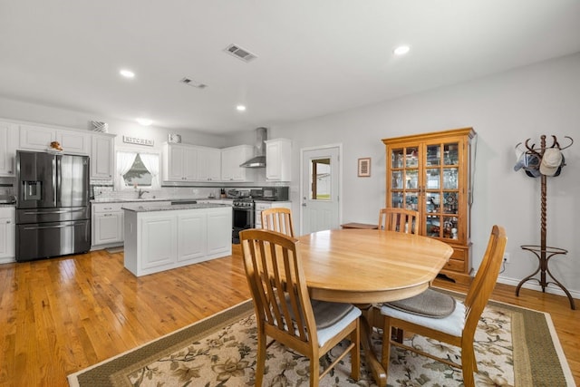 dining area with light wood-type flooring