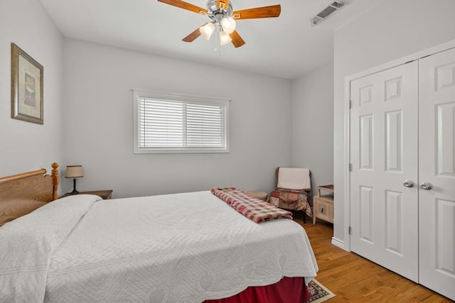 bedroom featuring ceiling fan, a closet, and light hardwood / wood-style floors