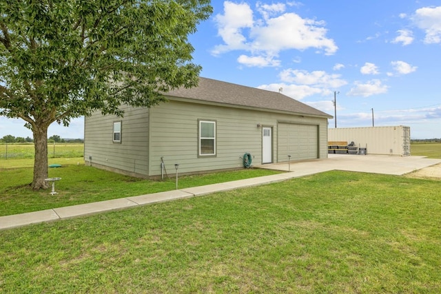 1881 County Road 251, Florence, TX 76527 - back of house featuring concrete driveway, a yard, a garage, and an outdoor structure