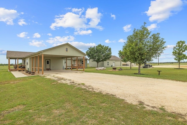 rear view of house with a garage, a lawn, and a carport