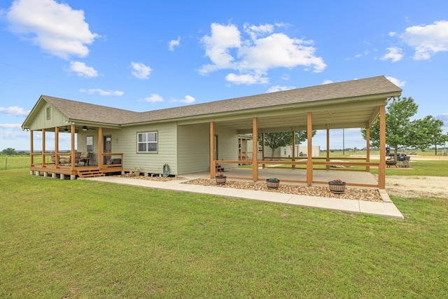 back of property featuring covered porch and a lawn