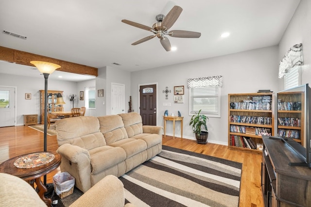 living room with ceiling fan and hardwood / wood-style floors