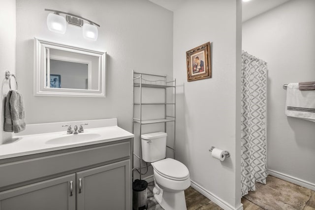 bathroom with toilet, wood-type flooring, and vanity