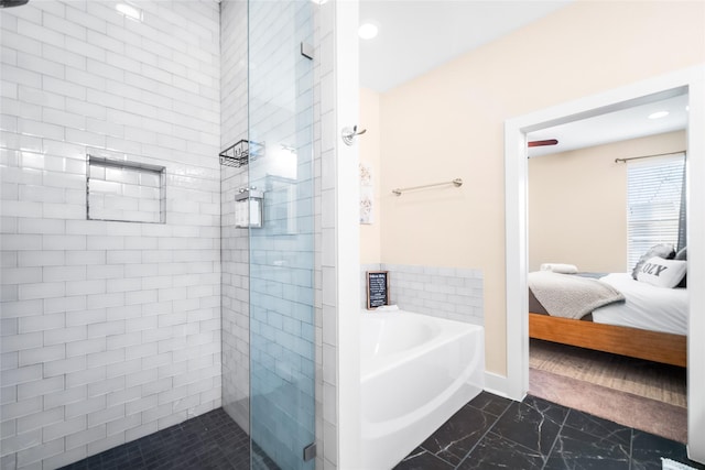 bathroom featuring separate shower and tub