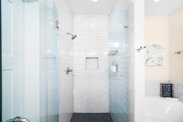 bathroom featuring separate shower and tub