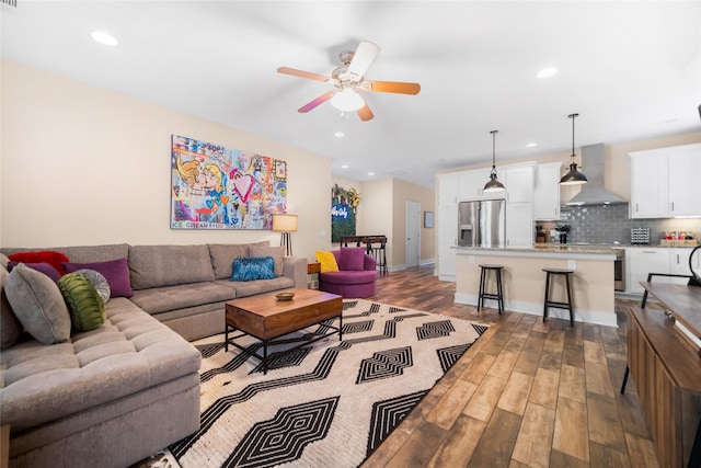 living room with dark wood-type flooring and ceiling fan