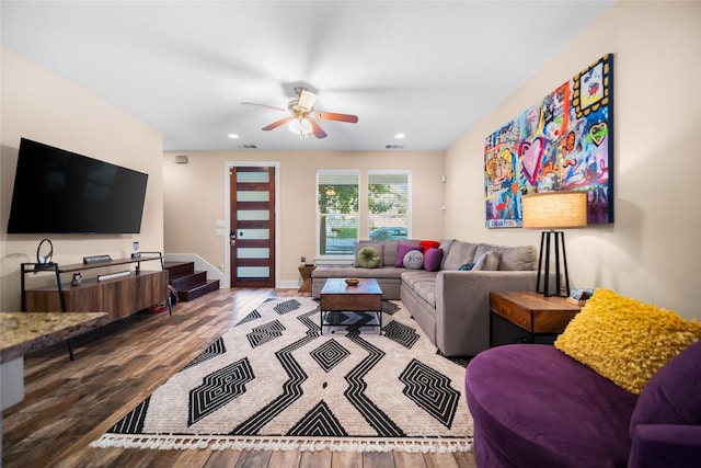 living room featuring ceiling fan and light hardwood / wood-style floors