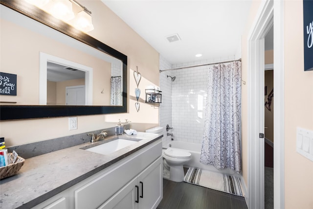 full bathroom featuring toilet, vanity, and shower / tub combo with curtain