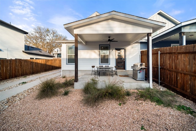 rear view of house with ceiling fan and a patio