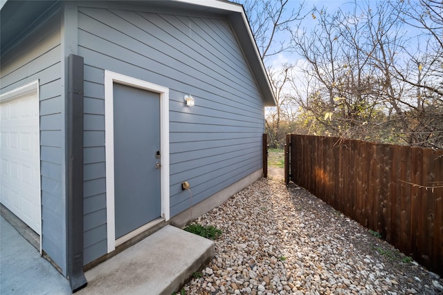 view of property exterior featuring a garage and an outdoor structure