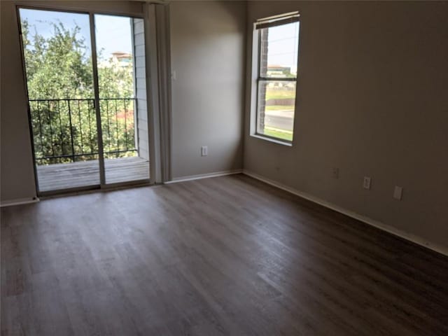12166 Metric Blvd Unit 341, Austin, TX 78758 - unfurnished room with plenty of natural light, dark wood-style floors, and baseboards