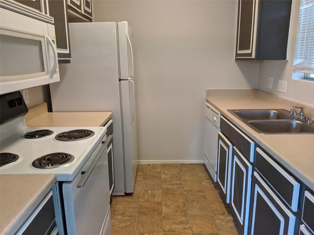 12166 Metric Blvd Unit 341, Austin, TX 78758 - kitchen with white appliances, a sink, light countertops, and baseboards