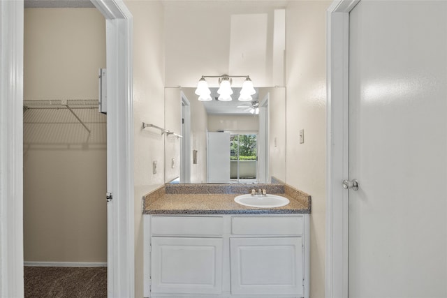 bathroom with ceiling fan and vanity