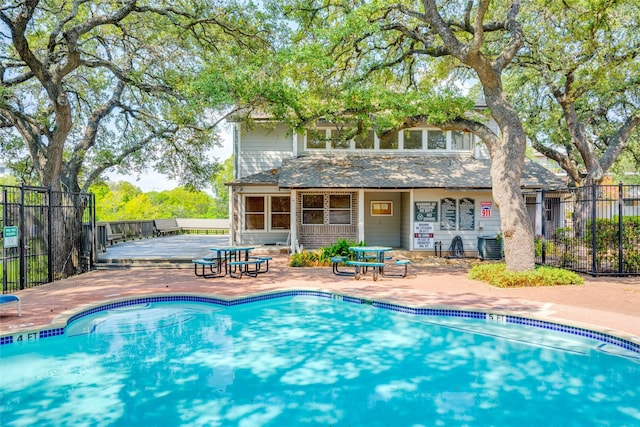 view of pool featuring central AC unit and a sunroom