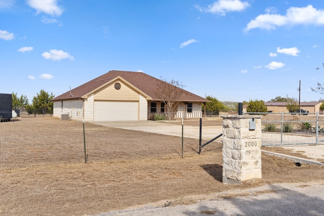 view of front of home featuring cooling unit and a garage