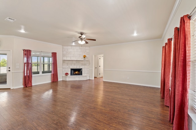 unfurnished living room featuring ceiling fan, a fireplace, crown molding, and dark hardwood / wood-style floors